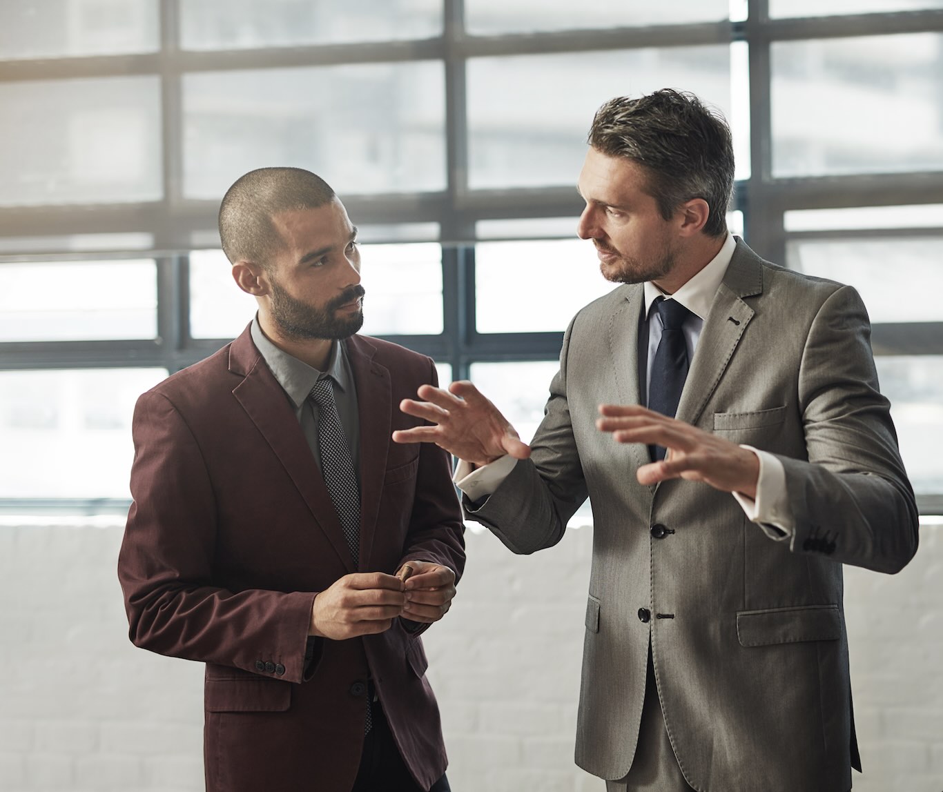Two business men discussion Intellectual Property and Artificial Intelligence from a company like Black Hills AI