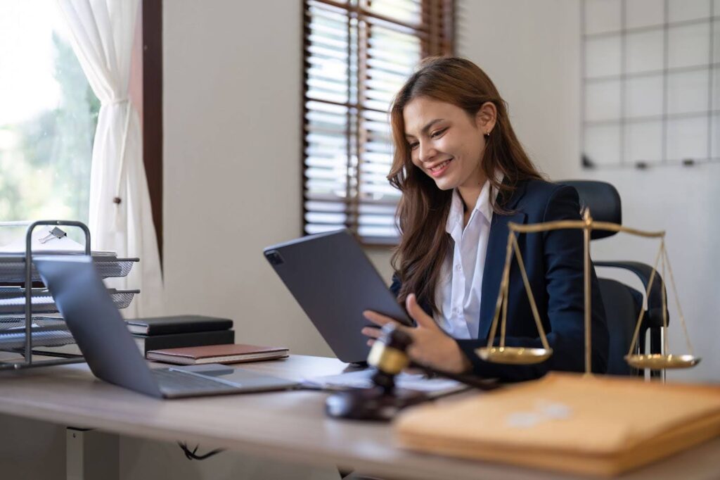 A lawyer smiling because she is using the best IP docketing solution for law firms on the market - Black Hills AI.